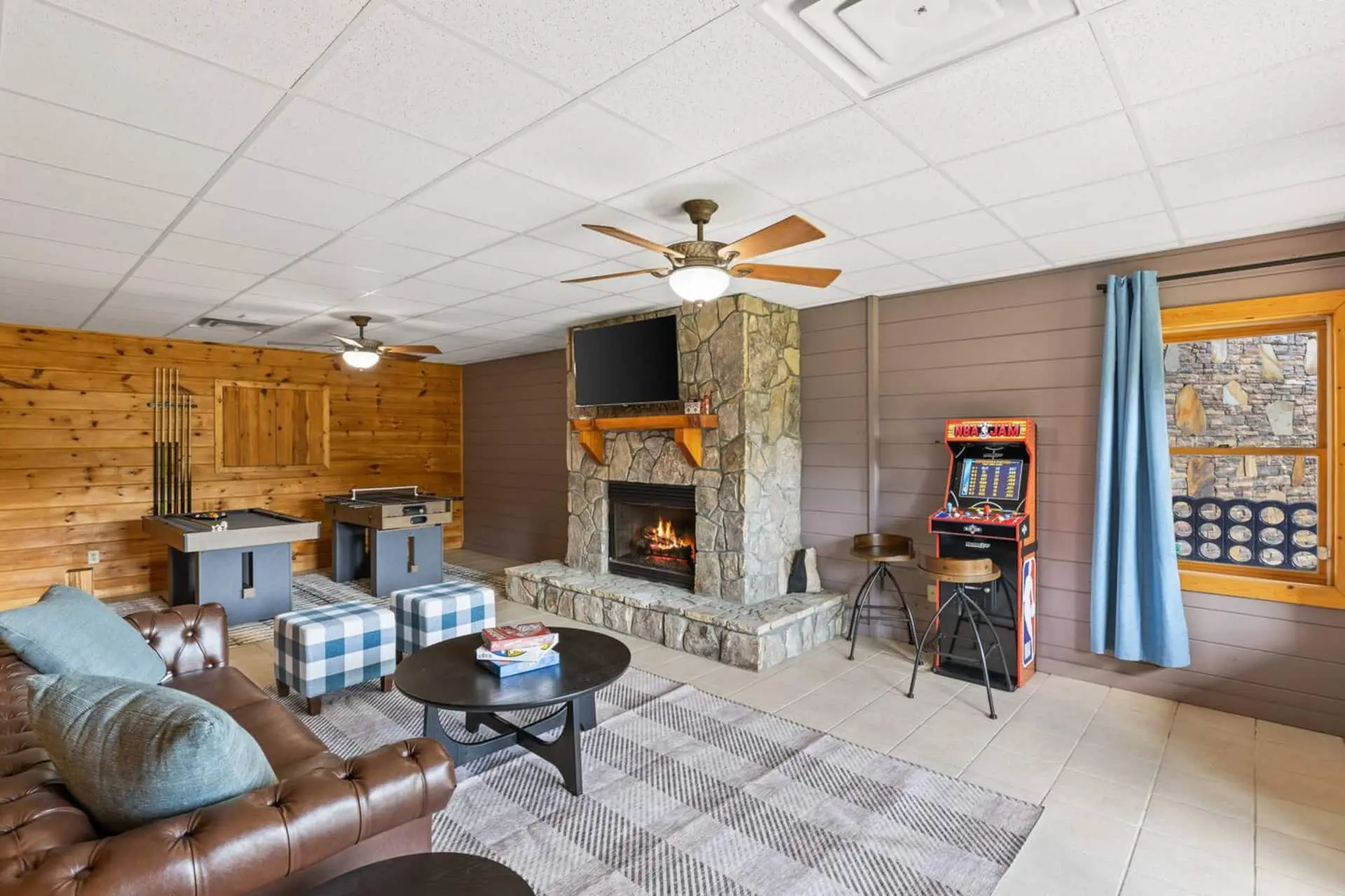 The ultimate hangout space! This inviting game room features a cozy stone fireplace, big-screen TV, pool table, and foosball for nonstop fun. Kick back on comfy seating, enjoy board games, and gather for movie nights or friendly competition.