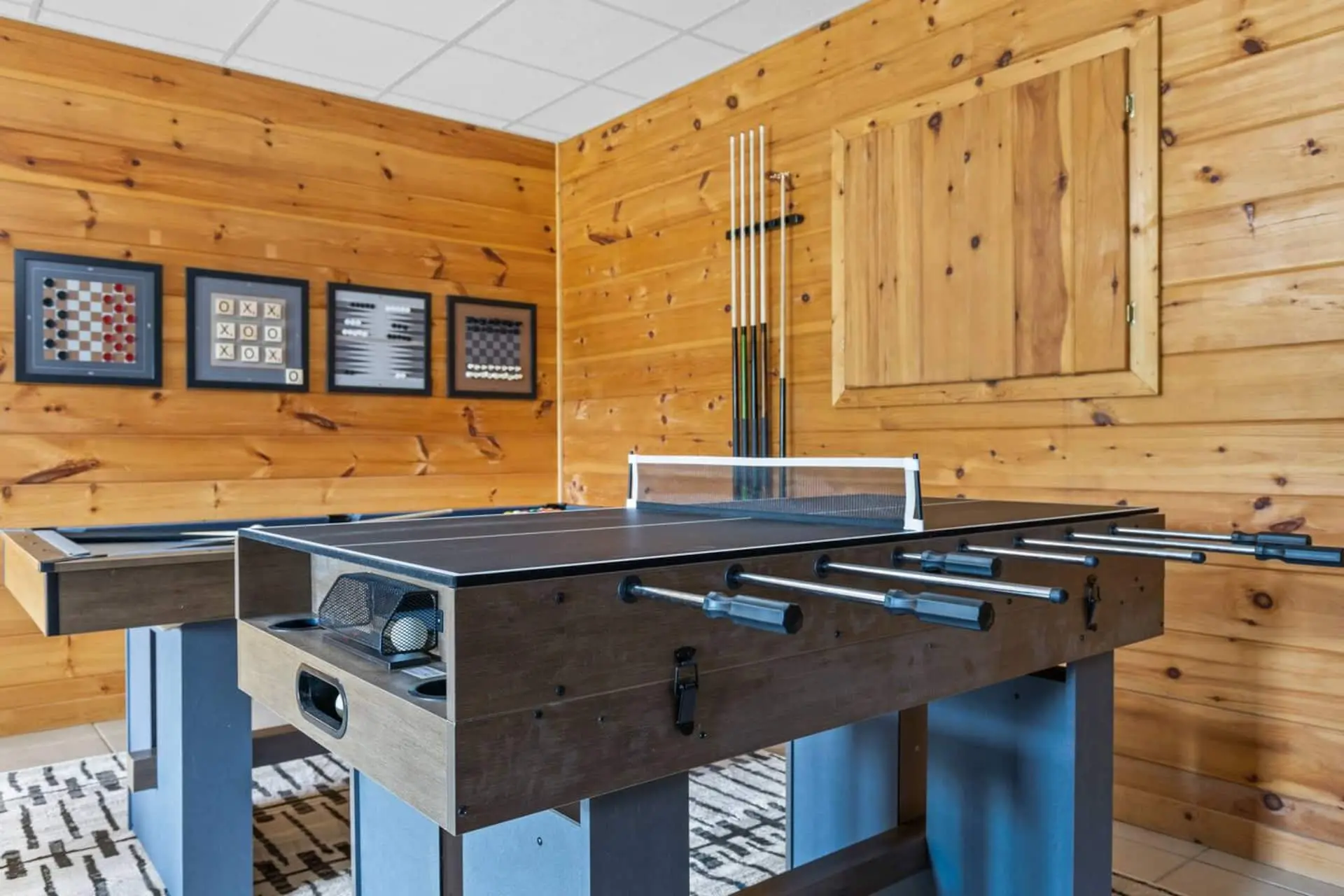 Double the fun in this woodsy game room featuring both foosball and a kid-friendly pool table! Challenge friends to a fast-paced match, then switch it up for a game of billiards—perfect for all ages and hours of indoor entertainment.