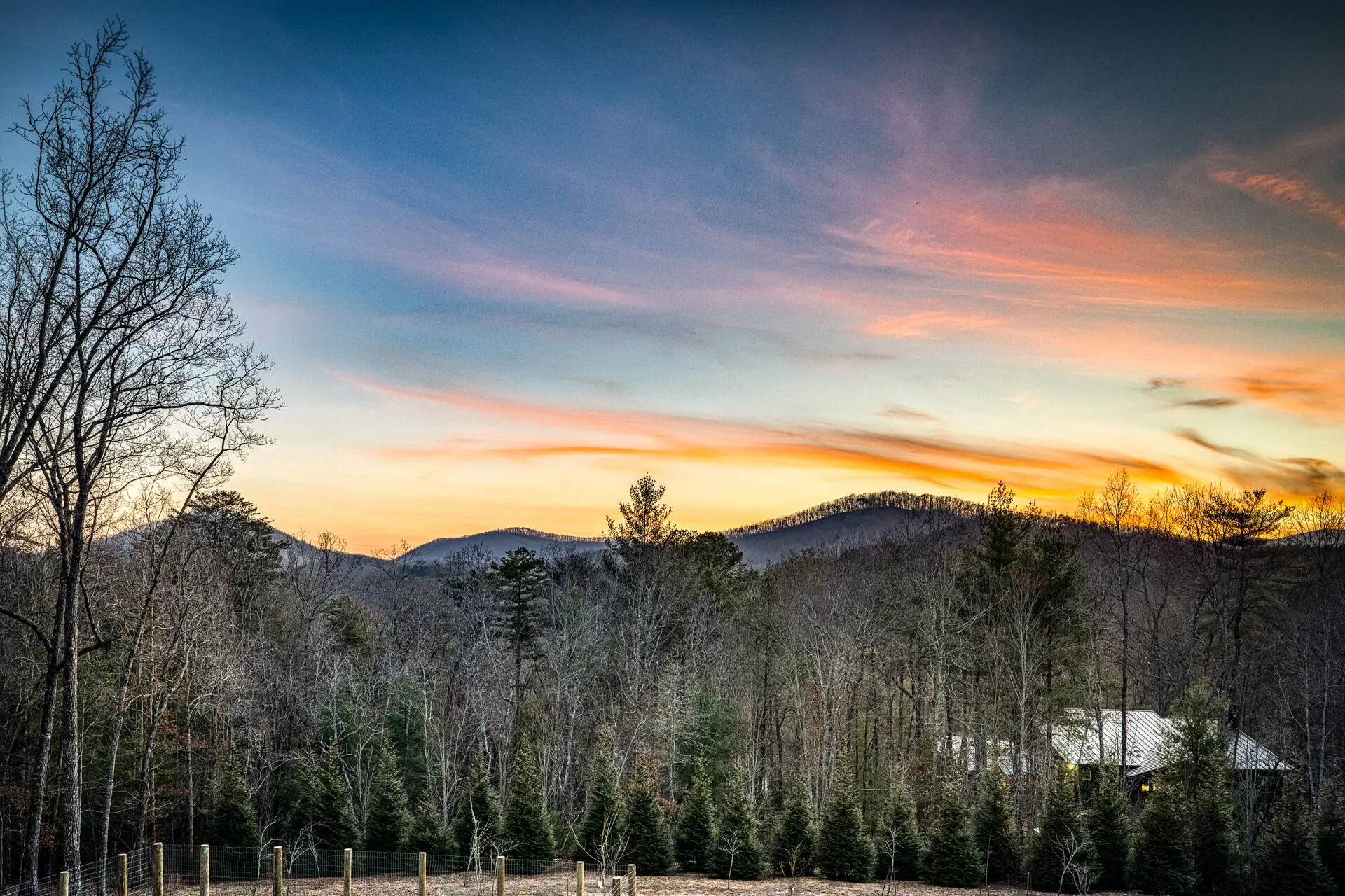 Sunset mountain vistas over wooded acres—private, peaceful retreat.